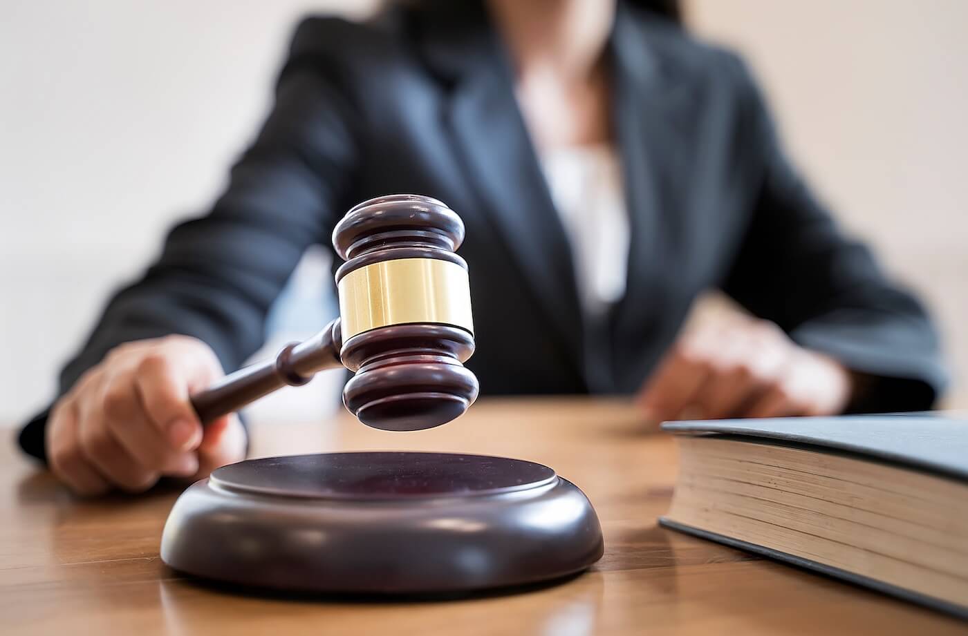 Judge holds a gavel to strike a sound block